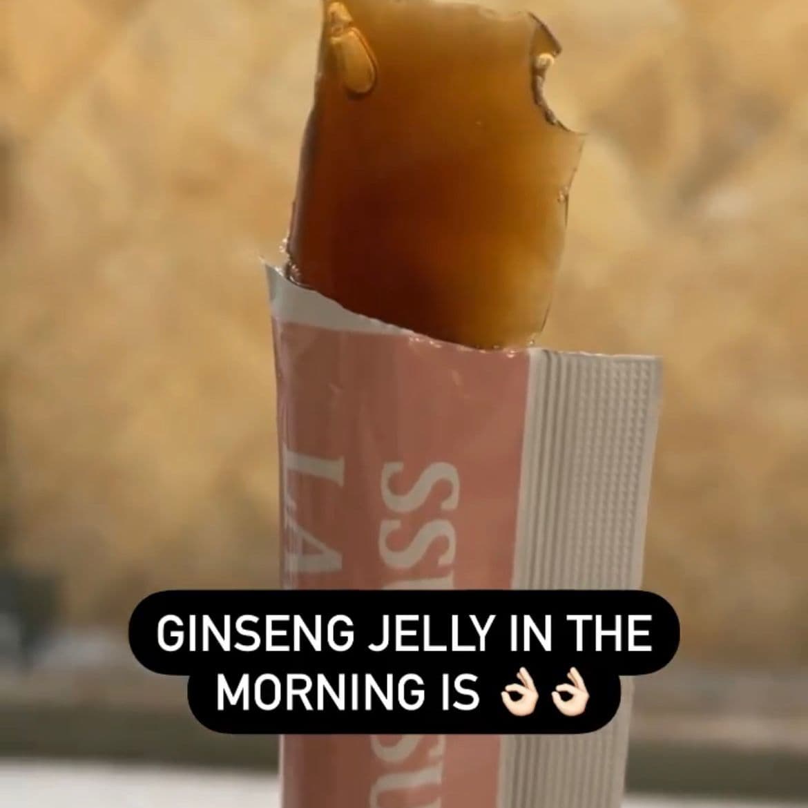 Blogger Olivia Phua, username IVIANATHUI, holding a sachet of ginseng beauty jelly, showcasing the jelly texture